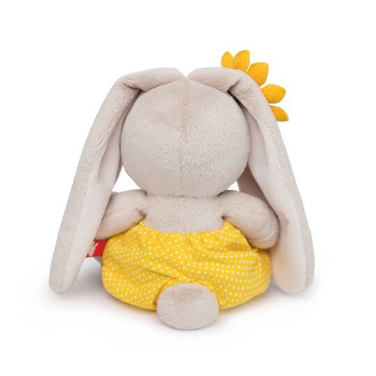 in a yellow polka-dot shorts and with sunflower in a yellow polka-dot shorts and with sunflower