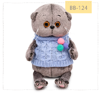 в вязаном жилете с помпонами