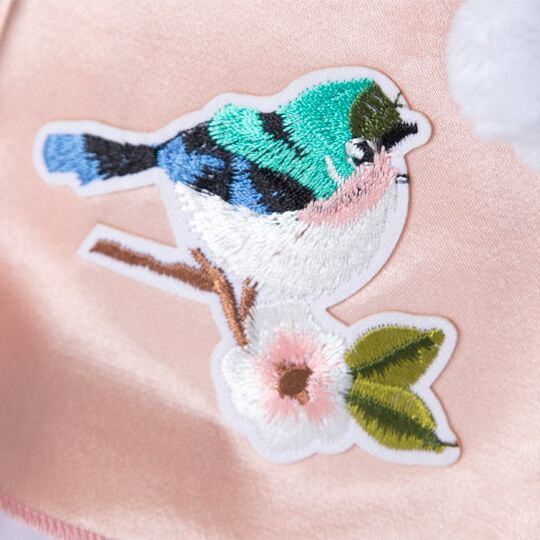 in a gently pink dress with a bird in a gently pink dress with a bird